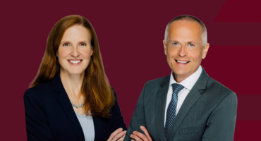 Dr. Martin Braun und Silke Laubscher vor rotem Hintergrund